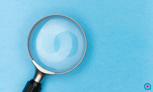 Magnifying glass on a blue background.