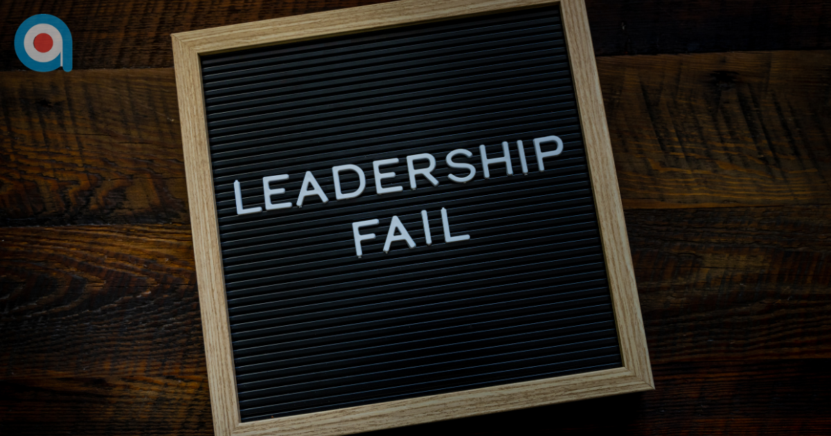 Black letter board with white text reading “Leadership Fail” on a wooden background