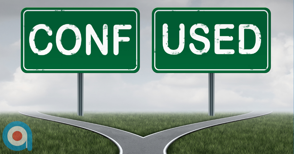 Fork in the road with two green road signs reading 'CONF' and 'USED' (spelling CONFUSED), showing two diverging paths on grass with cloudy sky background. With Target Training Associates logo in the bottom left hand corner.