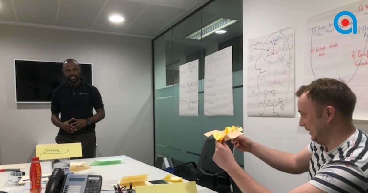 Trainer facilitating practical workplace training focused on performance